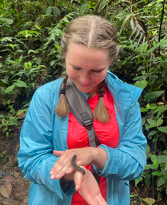 Photo of ONU student letting a bug crawl on her hand