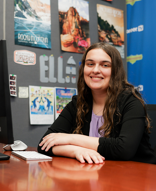 Photo of Ella sitting in a office 