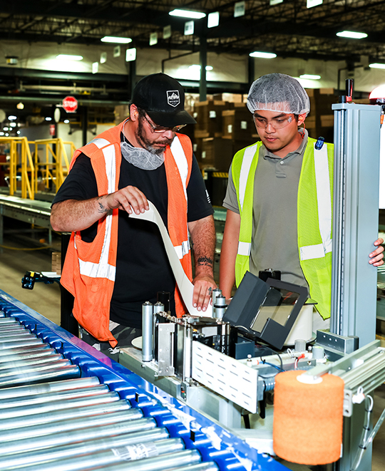 Photo of Long working on a production line