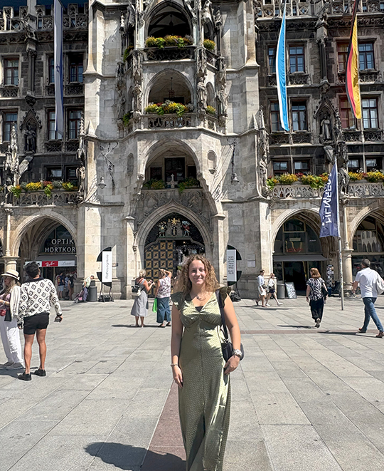 Photo of Emma in front of a beautiful building