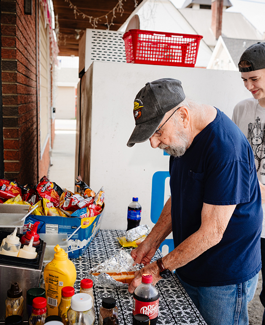 Photo from Carryout Restaurant, another patron is putting fixings on his meal