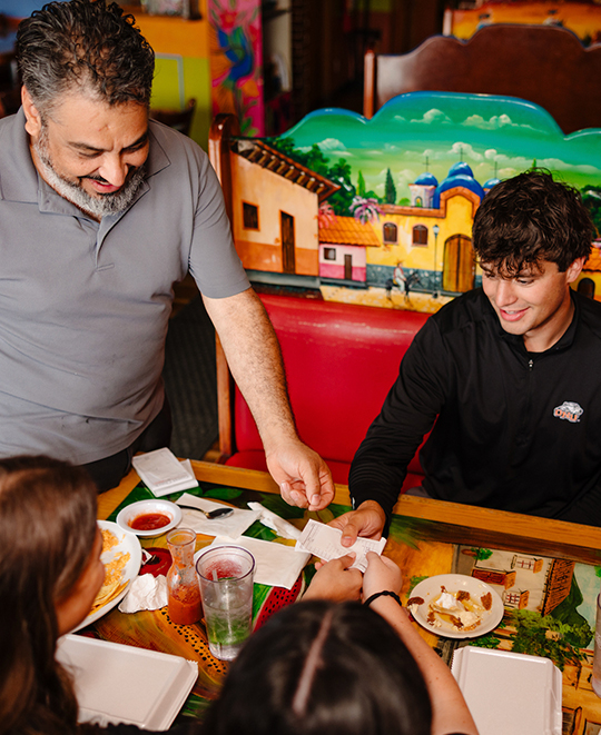 Photo from El Campo Restaurant, waiter bringing bill to table