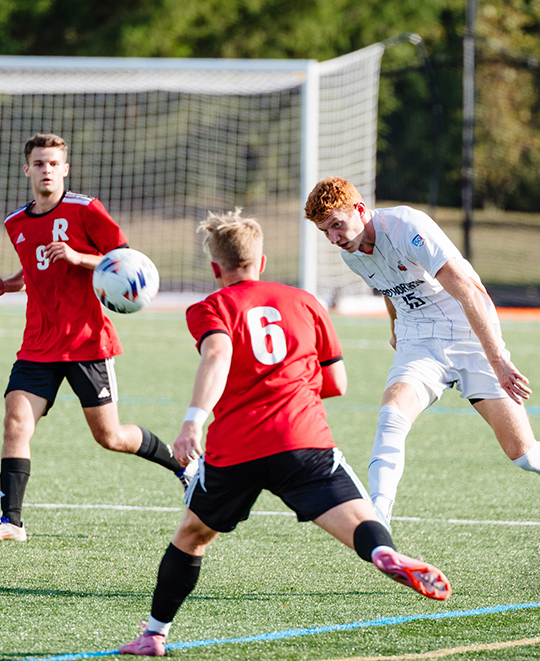 Photo of ONU men soccer player hitting the header forward to other players