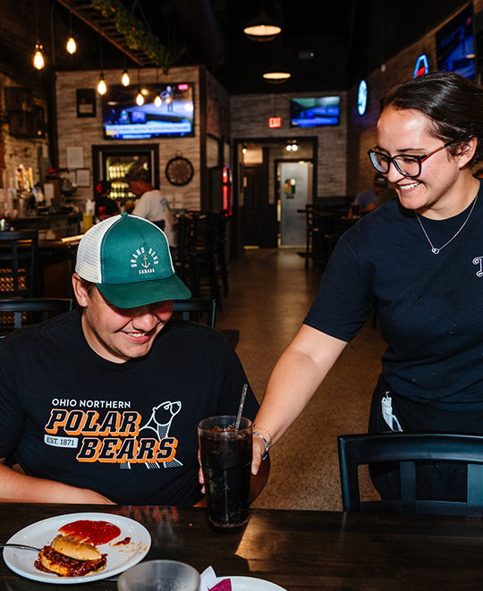 Photo from the Tavern Restaurant, waitress delivering food to table