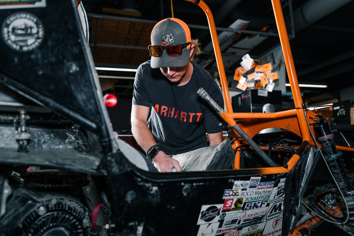 Student working on Baja car