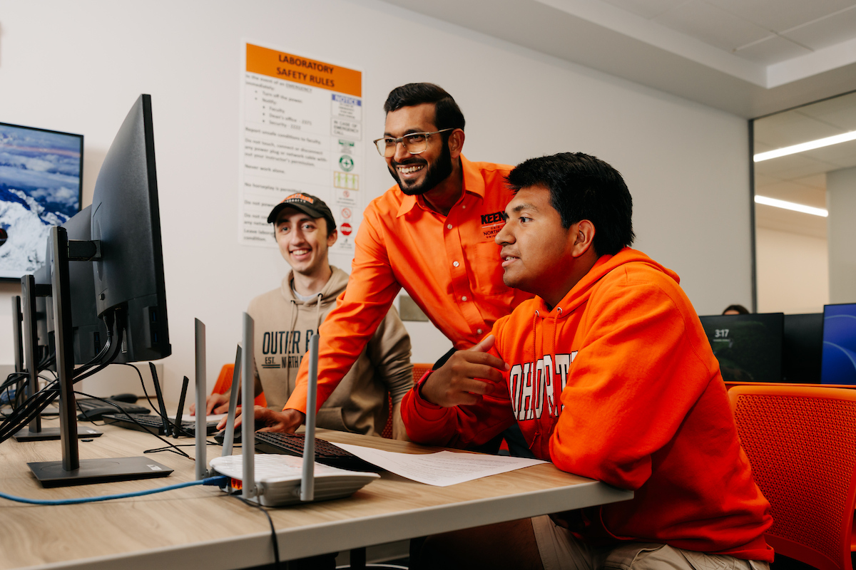 Professor helping students in class