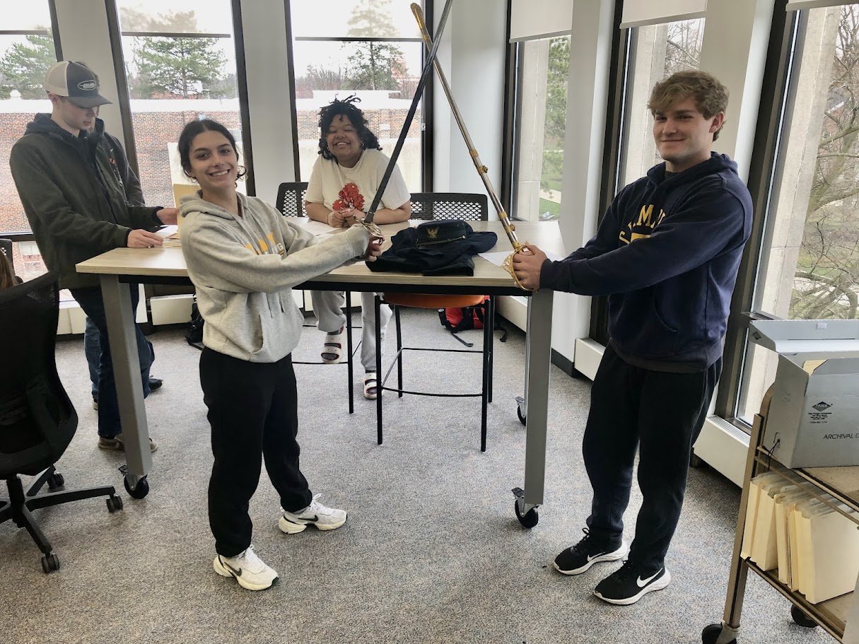 ONU students inspect the ceremonial sabers held in the ONU Archives. In the years before WWI, there was a Military Department at ONU!