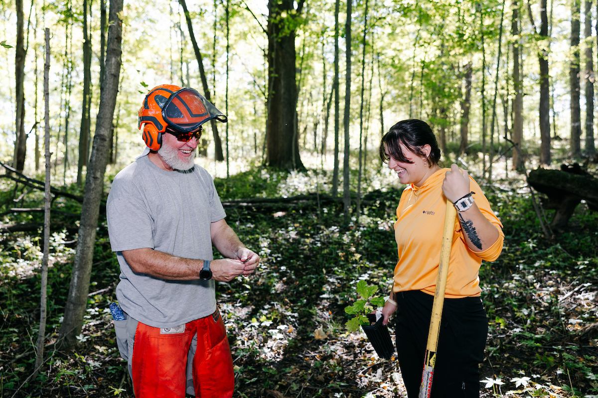 student and professor out in the wetlands