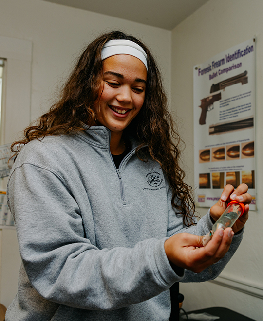 Photo of ONU student looking at a specimen tube