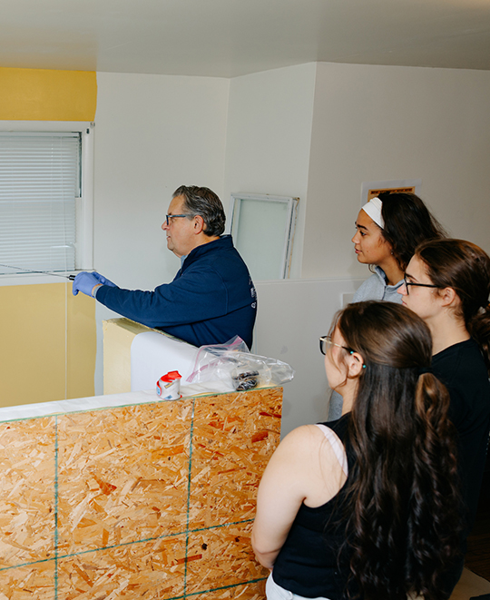 Photo of ONU instructor demonstrating forensic process while students watch