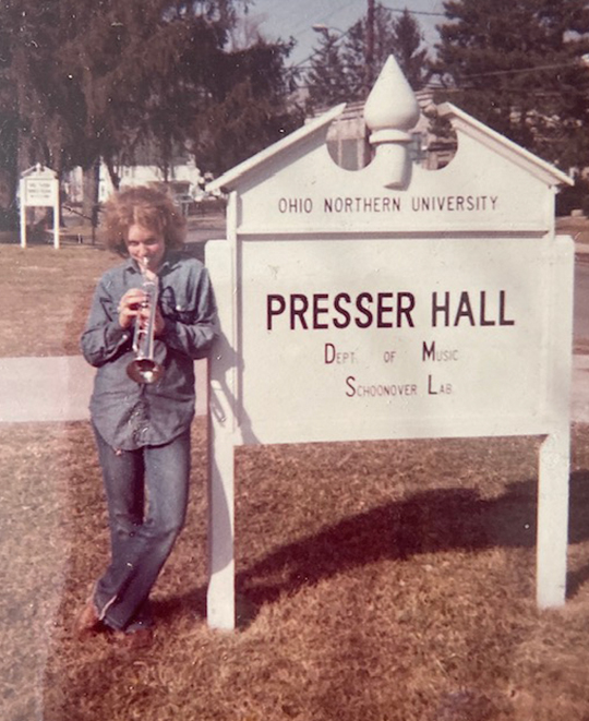 Old Photo of ONU student standing by Presser Hall Outdoor Signage