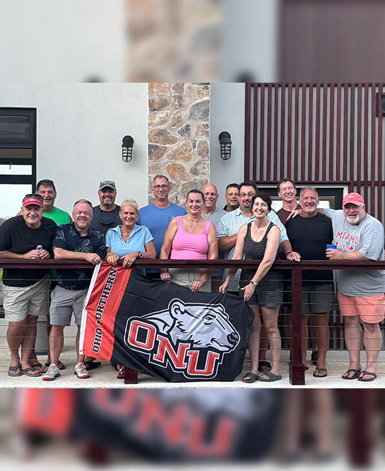 Photo of ONU group on a balcony holding ONU flag