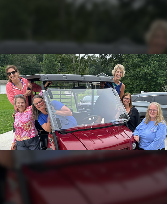 Photo of the friends posing hanging out of a golf cart