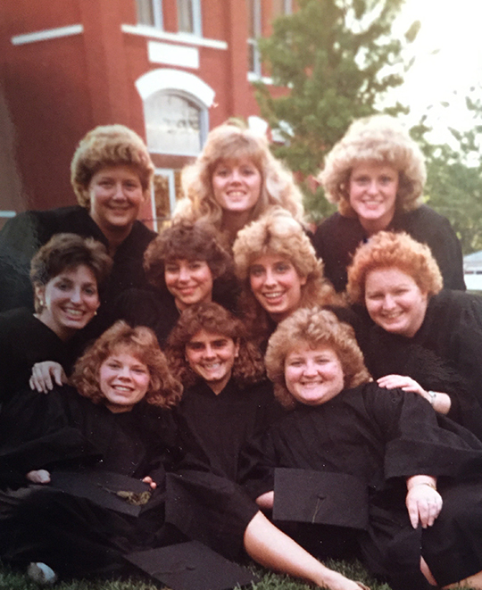 Photo of the friends in their college days posing together in their caps and gowns