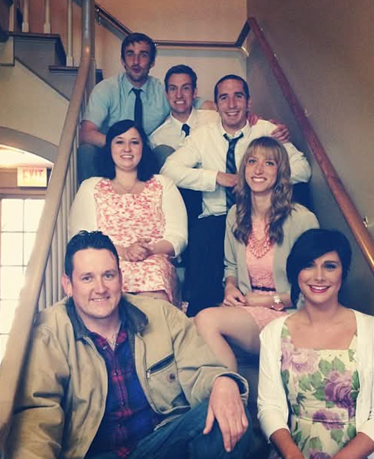 Photo of the group posing seated on the stairs