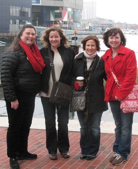 Photo of 4 of the ladies on a pier together