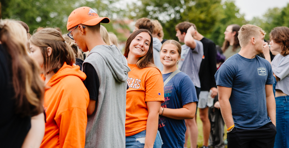 two female students smiling outside
