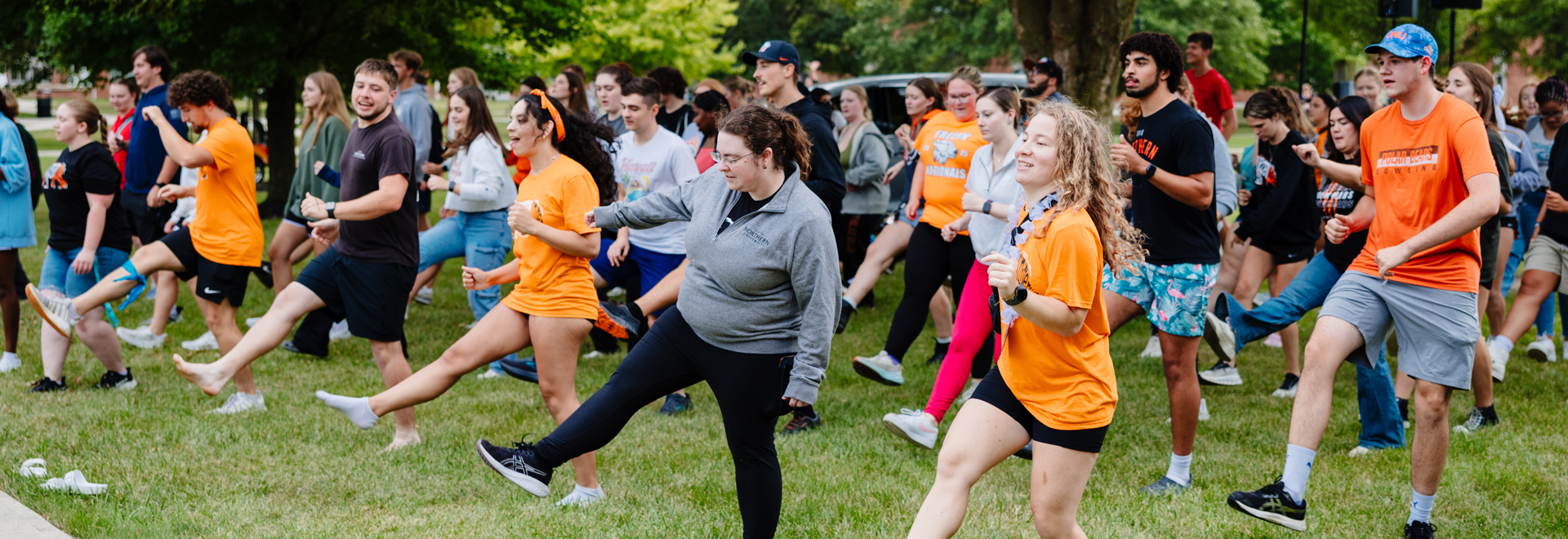 a large group of new students dancing outside