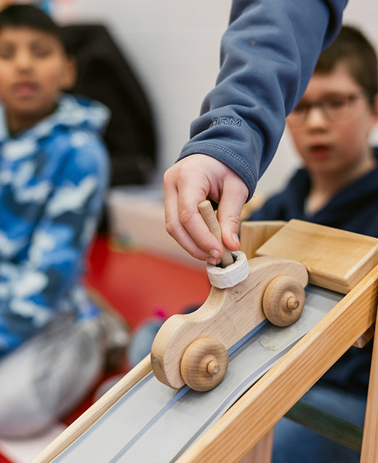 Close up photo of the wooden car that the students were using