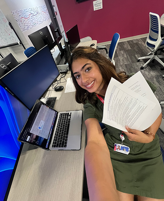 0.5 selfie of Simran in front of a monitor