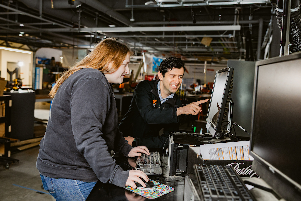 Professor with student in steel bridge assignment