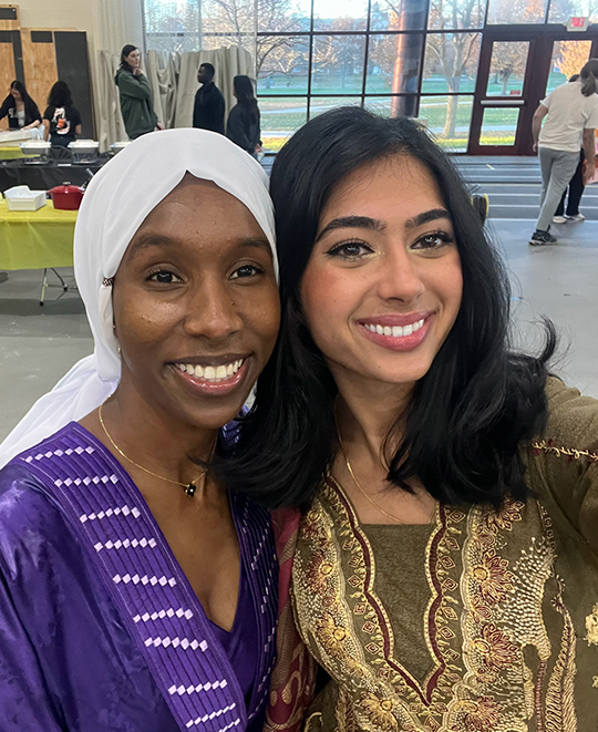 Selfie of Simran in a olive green Punjab on posing next to a friend wearing a purple outfit