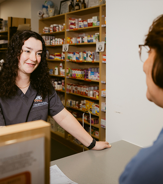 Hailey at the counter speaking with a customer