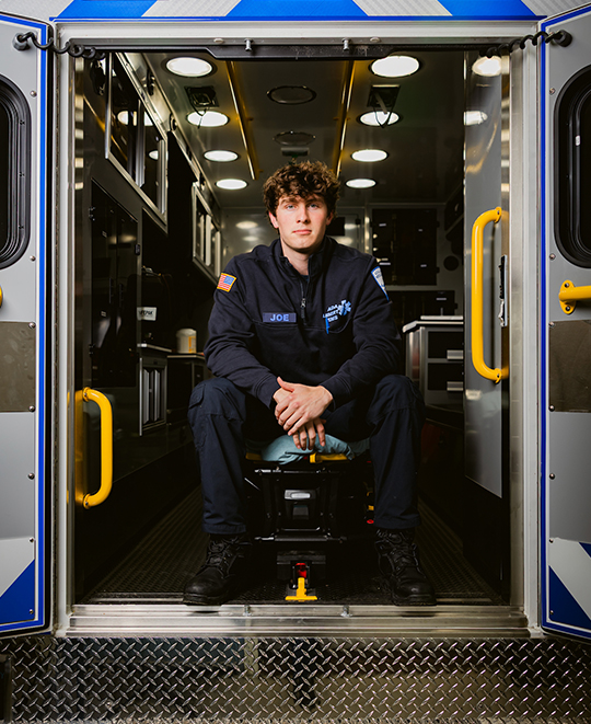 Joey posing from inside the back of an EMS