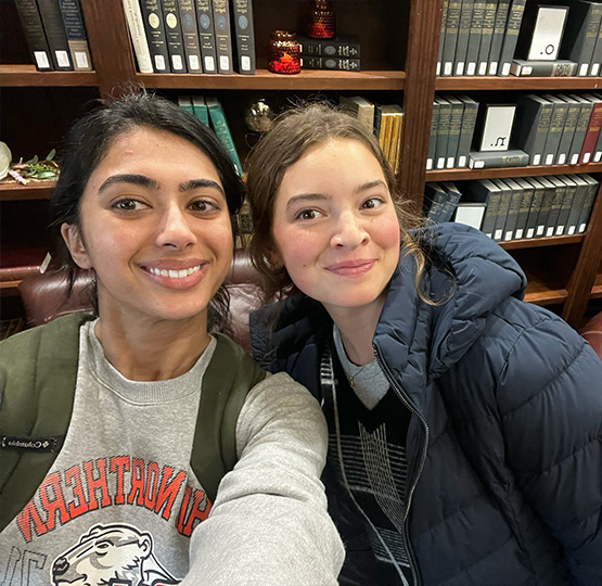 Simran and a friend taking a selfie in the law library