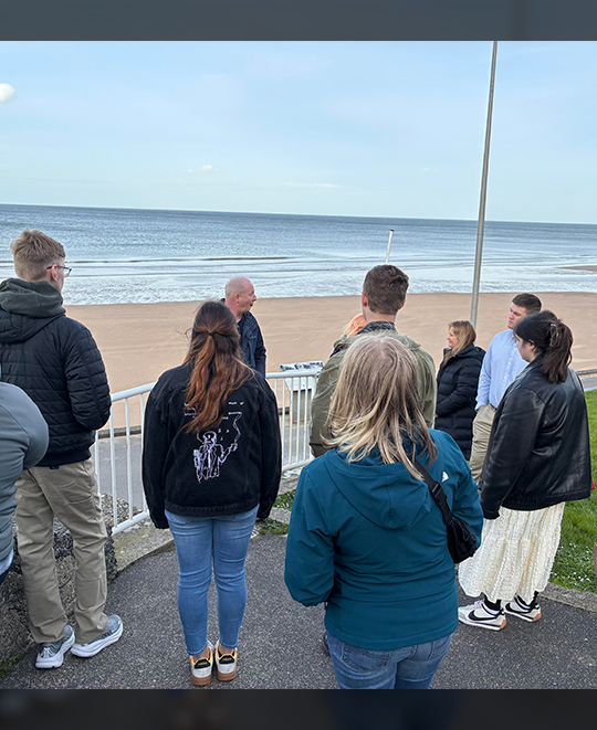 ONU history students visiting the historic Omaha Beach shoreline during their World War II memory tour.
