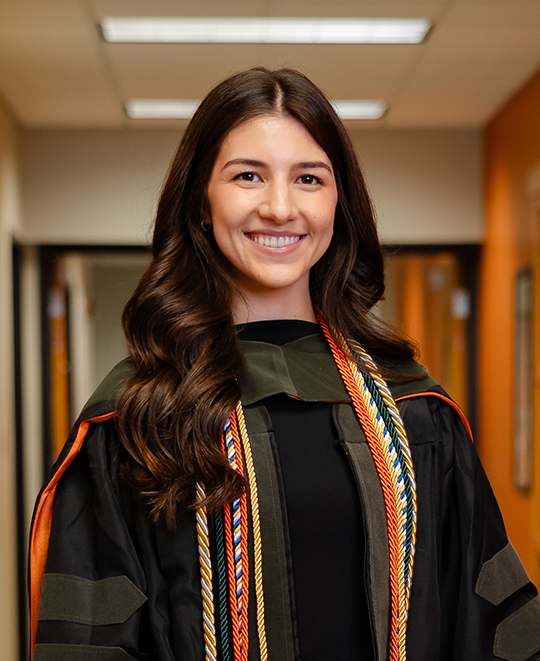 Samantha wearing her graduation gown and ropes