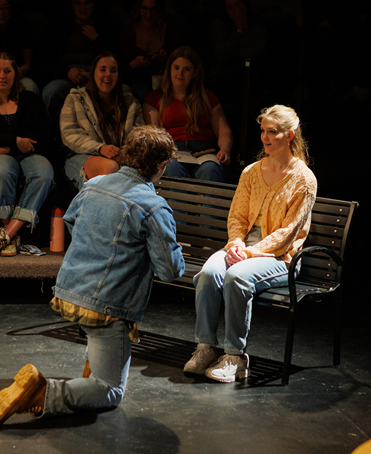 Dates show with female seated on a bench with a male on one knee directly in front of her