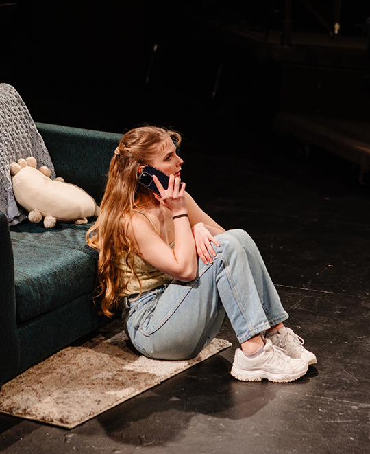 Dates show with female seated on the floor while talking on the phone