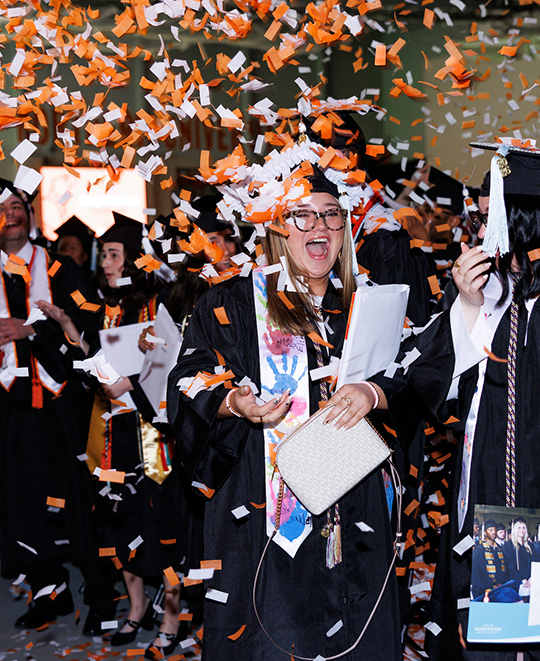 ONU graduates celebrating 2026 commencement with orange and white confetti