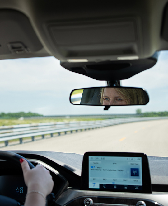 View from inside a vehicle driving on a multi-lane automotive test track at the TRC facility.