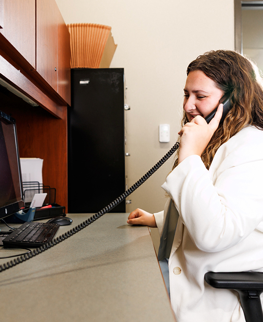 Evelynn Schneider speaking into a phone.