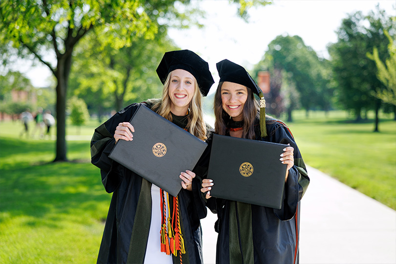 2 ONU students in their graduation caps and gown
