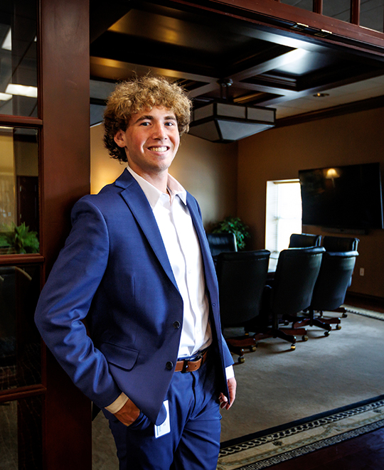 Tyler Wood standing outside an empty conference room.
