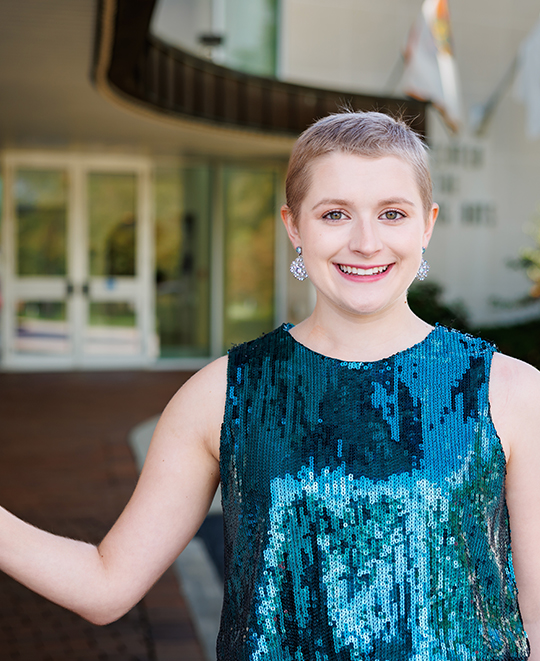 Cassandra Kurek smiling in a teal sequined top