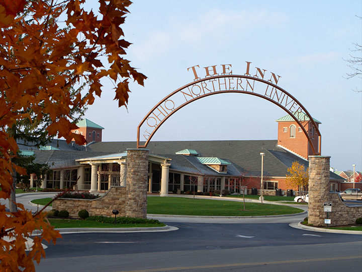 The entrance archway and front façade of The Inn at Ohio Northern University on a clear day