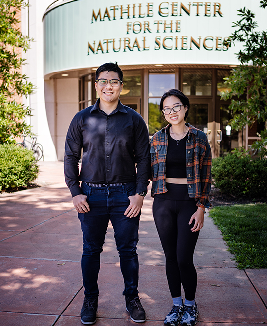 Siblings Triet and Uyen pose in front of Mathile Center