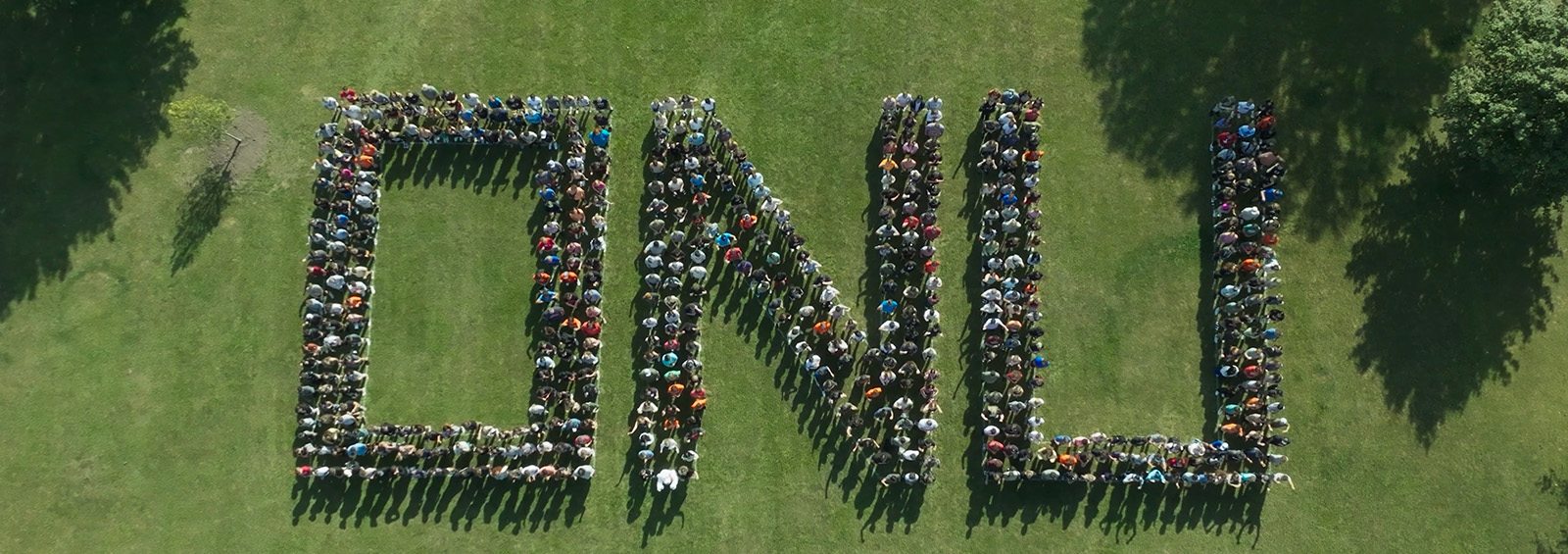 Students & Staff standing on lawn spelling O N U 