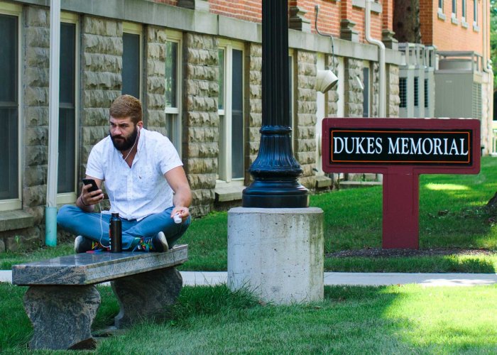 student on phone at dukes