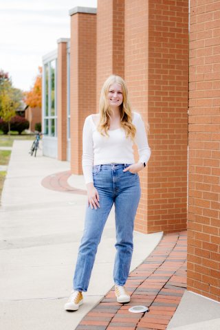 Photo of Allison standing by building