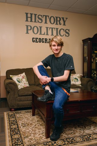 Photo of Gabriel with History Politics sign behind him