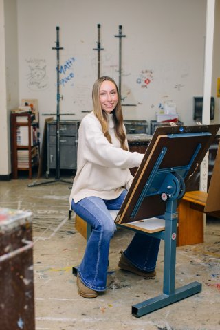 Photo of Avory at an art easel 