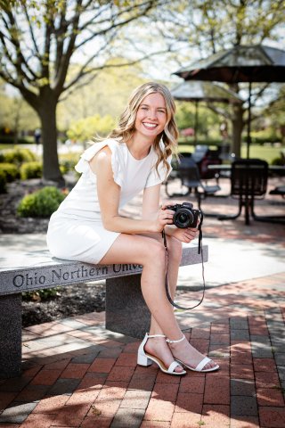 Photo of Maiya holding a camera