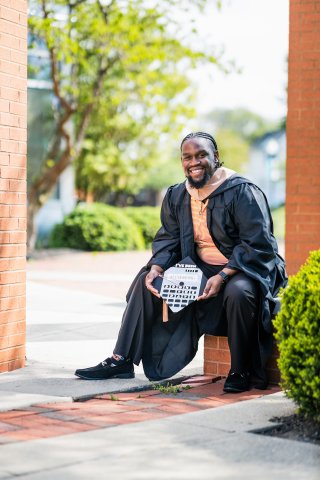 Photo of Xavier in his cap and gown