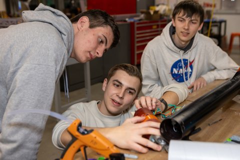 Photo of ONU students working together on a rocket