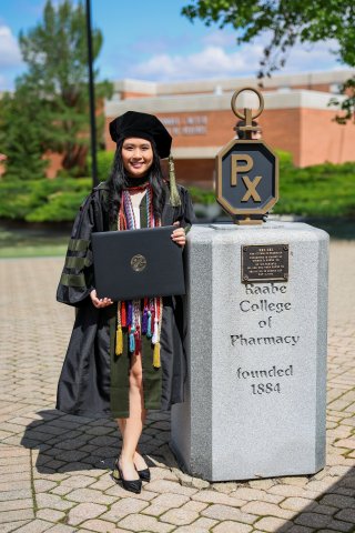 Photo of Brianna standing next to ONU statue